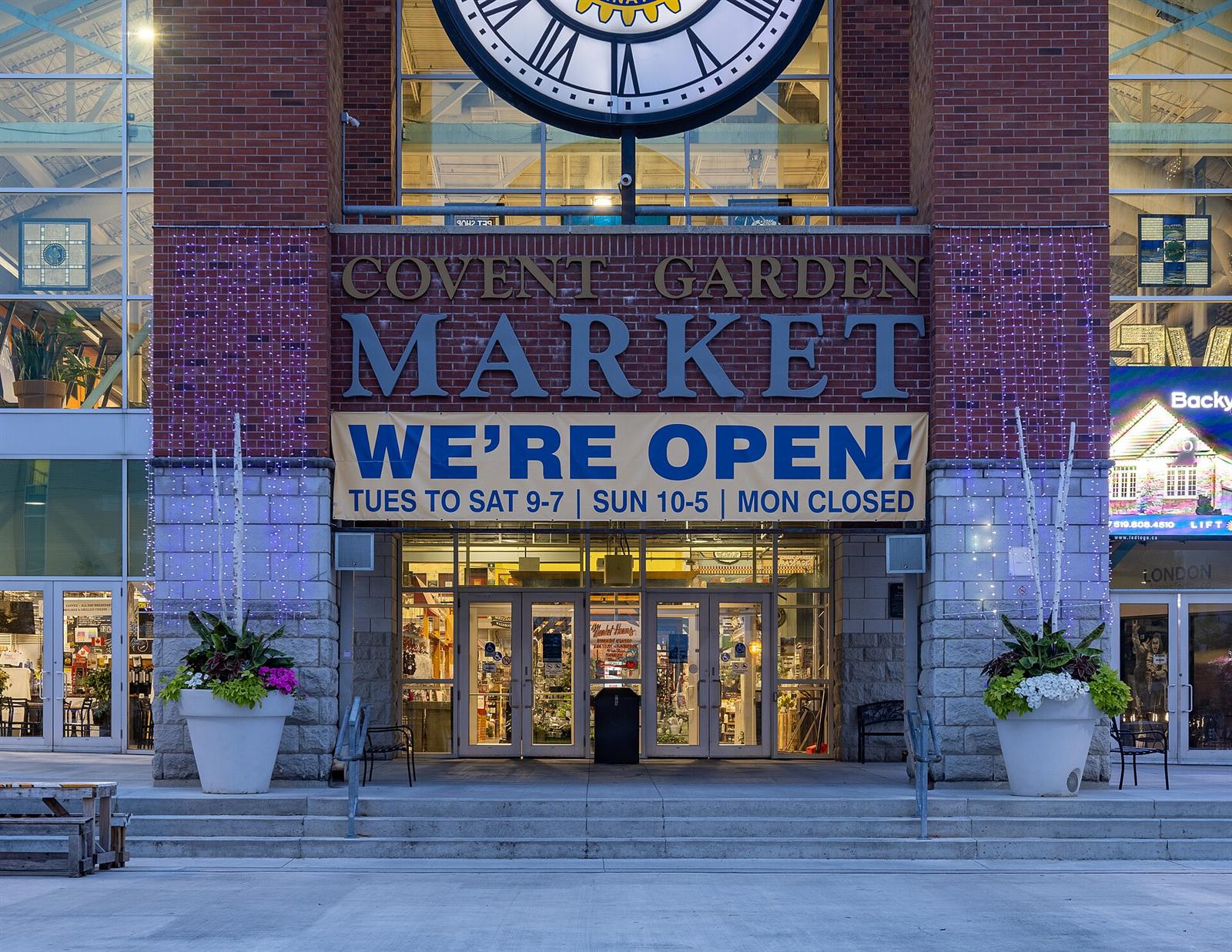The entrance of Covent Garden Market in downtown London, Ontario, with an opening-hours banner