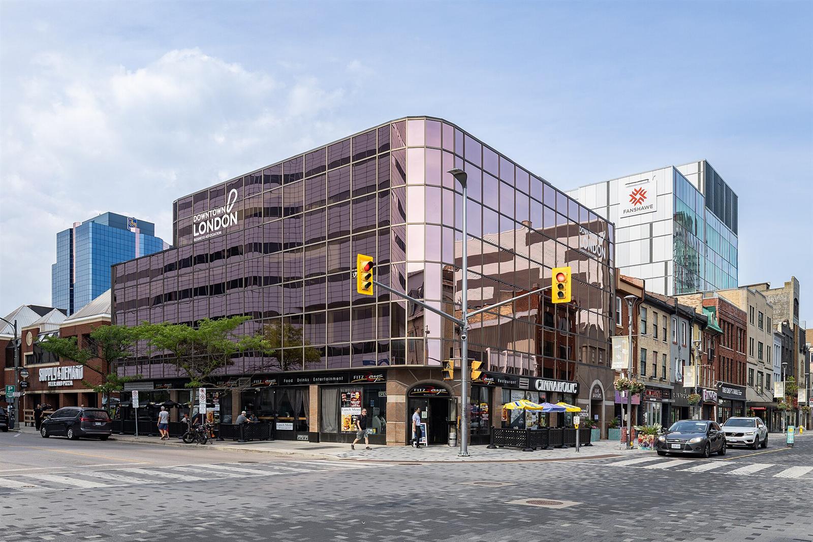 Shops, cafés and a restaurant patio at a corner on Dundas Street in downtown London, Ontario